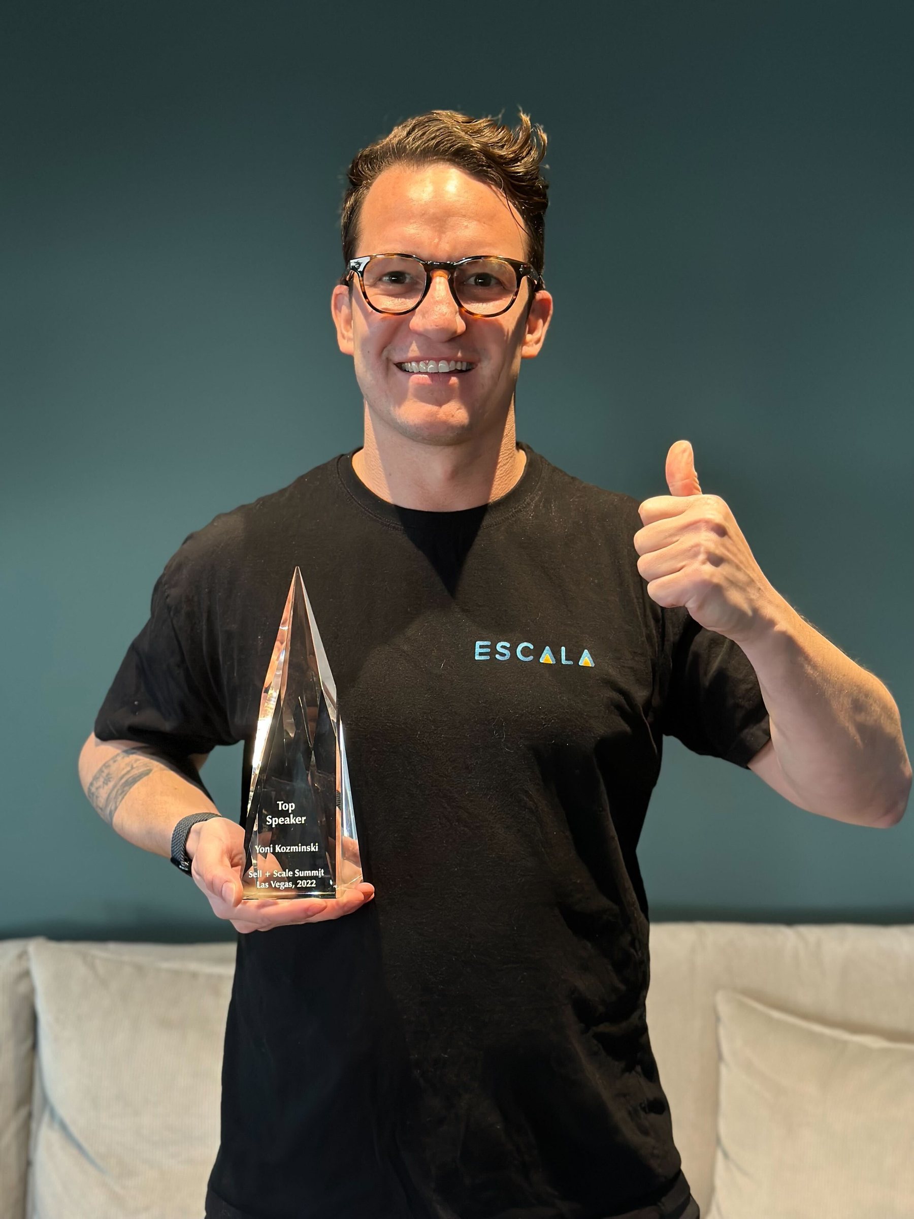 Yoni Kozminski holding Sell and Scale best speaker trophy